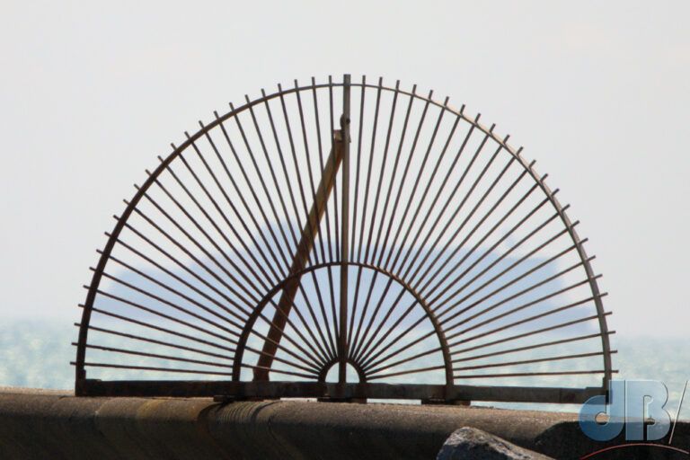 Sea wall fence at Kingsdown, with passing ship