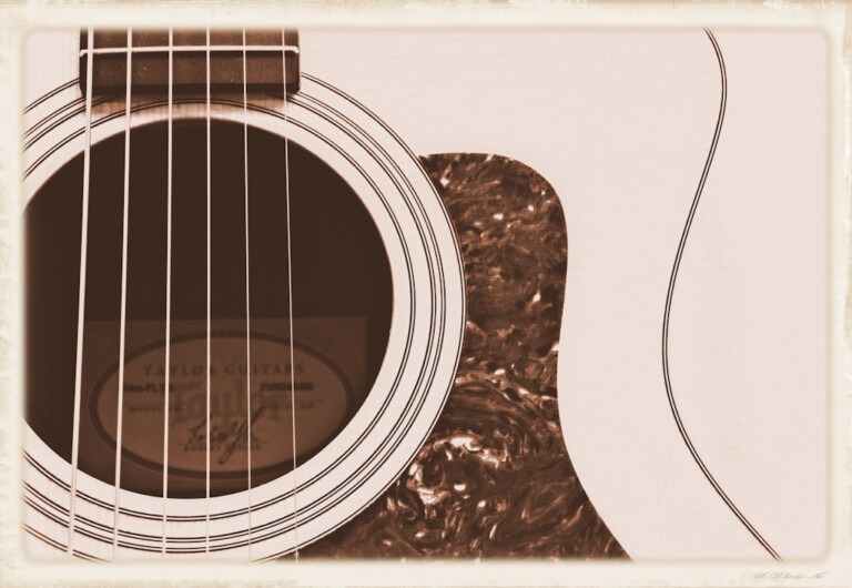 Sepia tone closeup of strings and sound hole on my Taylor acoustic guitar